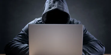 computer hacker stealing data from a laptop