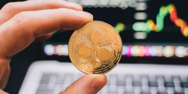 Ripple XRP coin in front of laptop screen scaled 1