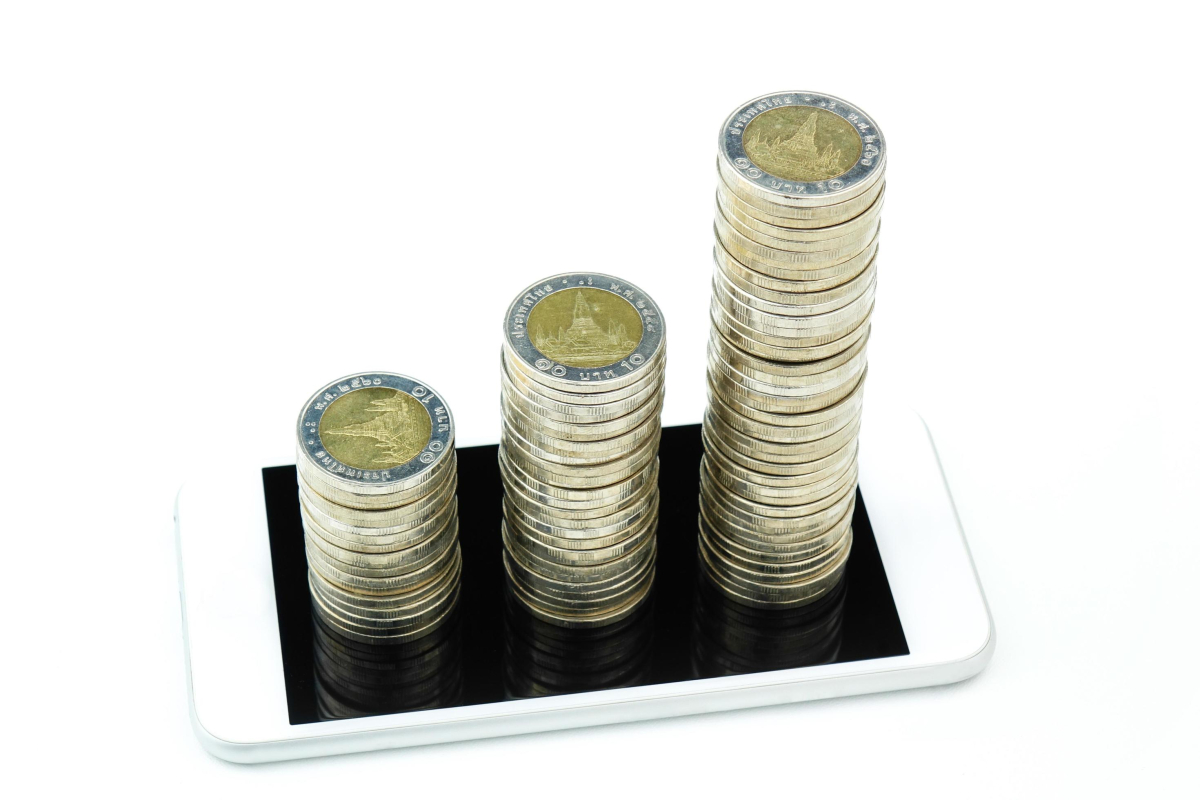 a coin stack growth increase on smart phone business concept free photo scaled